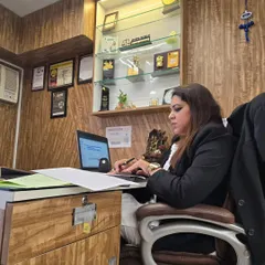 Focused at my desk. The quote "If there is no struggle, there is no progress" by Frederick Douglass perfectly captures the spirit of my legal practice. Every challenge is a step forward.