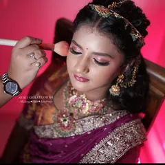 Creating a doll-like look for a traditional half-saree function. This shot shows the blush application, a key step in bringing warmth and dimension to the face.