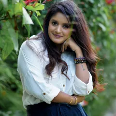 A lovely outdoor portrait of a woman with a gentle smile, surrounded by nature. These sessions are all about capturing your natural beauty.