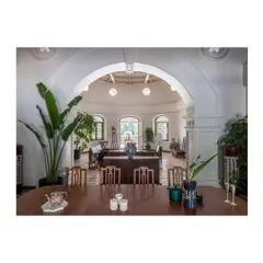 Looking through a restored archway into the central rotunda. This architectural feature became a focal point, connecting different zones of the home and drawing natural light deep into the interior.