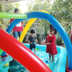 A glimpse of our Holi week fun, where even the littlest ones can enjoy the water play under our rainbow sprinkler.