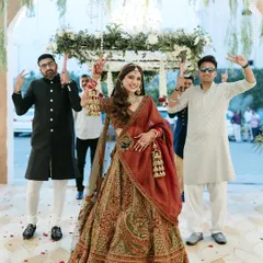 The bride's grand entry under a 'phoolon ki chadar', with her brothers striking a fun pose.
