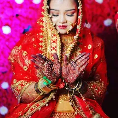Here is another one of my brides, looking absolutely radiant on her wedding day. I created a classic Indian bridal look for her with warm, shimmery eyeshadow and a traditional red and gold lehenga. Her hands, adorned with my intricate henna work, complete the picture.