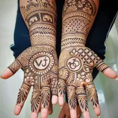 Your engagement mehandi can be a reflection of your love story. Here, I've incorporated the couple's initials "VJ" and engagement ring symbols into a traditional design filled with elephant motifs and detailed patterns.