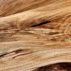 This image captures the mesmerizing swirls and patterns of the grain in a live-edge teak slab. This is the natural art that I aim to preserve in my dining tables.