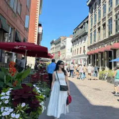 I create on-the-go content that feels authentic and captures a specific vibe. This shot from Old Port, Montréal, shows how I can model a brand's clothing in a real-world, bustling city environment, creating a candid and relatable travel story.