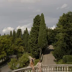 Overlooking the cypress trees of Tuscany from a historic villa. We seek out breathtaking views for our destination engagement shoots, creating frames that are as much about the landscape as they are about you.