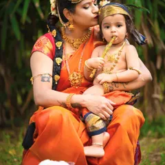 A tender kiss from Yashoda to her beloved Krishna. These outdoor sessions allow for beautiful, candid moments that feel timeless.