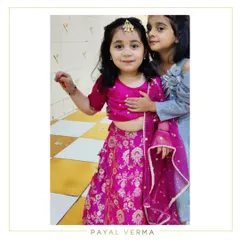 Pretty in pink. Little Zora is dressed in a custom hot pink Banarasi lehenga set for a festive occasion. The rich fabric and vibrant color make this a perfect choice for weddings and parties.