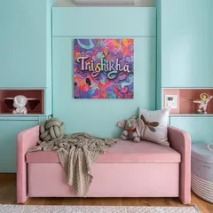 A happy space is a colorful space. This room for a young girl uses a cheerful palette of pastel blue and pink, with a personalized art piece and plenty of soft textures to make it feel cozy and fun.