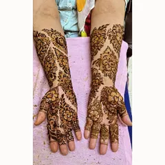 A beautiful example of asymmetrical floral design, where each hand has a unique but complementary pattern.