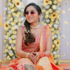 A full view of the bride's vibrant Haldi lehenga, perfectly complemented by her playful and fresh look.