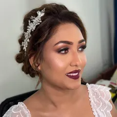 For this gorgeous Christian bride, we chose a sophisticated and glamorous look. I created a sparkling smokey eye and paired it with a bold wine-hued lipstick, complemented by an elegant bridal updo.