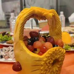 An example of our creative fruit displays. This pumpkin has been carved into an ornate basket, filled with a colourful assortment of fresh fruits. It’s both beautiful and delicious.