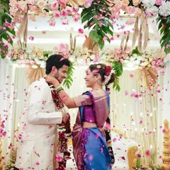 The joy of a wedding is infectious, and our goal is to capture that energy. This shot of a Varmala ceremony, with petals showering the happy couple, freezes a moment of pure celebration and laughter, reflecting the vibrant spirit of an Indian wedding.
