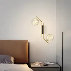 Coming soon to our collection, this beautiful wall fixture features two glass globes with an internal starry light effect, mounted on a gracefully curved arm. It's an ideal choice for a bedside wall lamp, adding a soft and decorative glow.