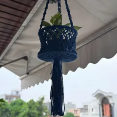 This multipurpose basket in a deep navy blue can be used as a hanging planter or for storage. It adds a unique touch to your balcony decor.