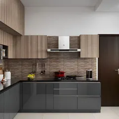 This L-shaped modular kitchen combines glossy grey base cabinets with wood-finish overhead units. We used a textured brown tile for the backsplash and ensured a seamless fit for the chimney and microwave, creating a modern and practical cooking space.