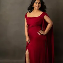 A pop of red to light up the day. This portrait in a stunning red gown is all about confidence and glamour, capturing a moment of pure, unapologetic beauty.