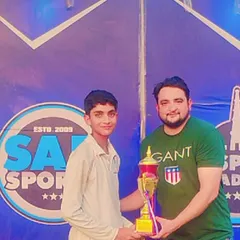 Recognizing individual brilliance. Here I am presenting a trophy to a standout player from one of my cricket tournaments.