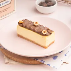My Hazelnut Praline Cheesecake slice, featuring a creamy baked cheesecake base topped with a rich, nutty chocolate praline layer.