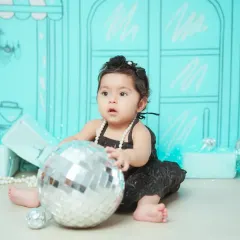 This little fashionista is playing with a disco ball prop in our custom 'Tiffany & Co.' setup.