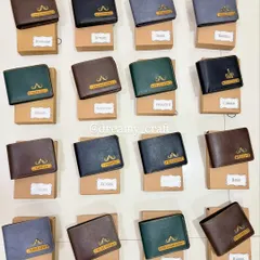 Here is a bulk order of personalized men's wallets I prepared as wedding return gifts. Each wallet was customized with a unique name and charm, and individually packed in its own box, ready to be gifted.