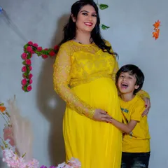 A joyful studio moment between a mother and her son. His happy laugh while hugging the baby bump is a precious memory that I love to capture for growing families.