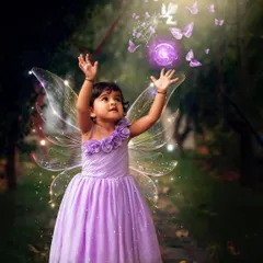 Reaching for the magic. This shot captures the wonder and imagination of childhood in our fairy-themed portrait session.