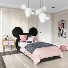 A charming Minnie Mouse themed bedroom perfect for a young fan. The iconic mouse ears form the headboard, and the room is decorated in a pink, black, and white color palette with a bubble-like chandelier.
