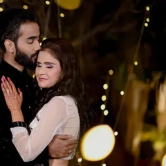 A romantic night portrait from an engagement ceremony at Amar Mahal, Orcha. The warm fairy lights create a beautiful bokeh effect, highlighting the couple's intimate embrace.
