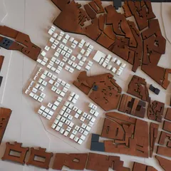 A closer view of an urban model, where we test different housing typologies. The contrast between the dark wood of the existing fabric and the white blocks of the proposed design allows for a clear analysis of the urban impact.
