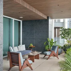 The breezy open deck of the Worli apartment serves as an extension of the living spaces. It provides a private outdoor area to unwind and take in the view, creating a sanctuary within the dense urban environment.