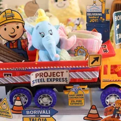 A close-up of the 'Project Steel Express' hamper. I filled this toy truck with a Dumbo soft toy and other baby essentials, adding fun construction-themed signs to complete the look.