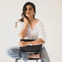 A playful, barefoot pose that adds a touch of personality. The clean white background keeps the look modern and fresh.
