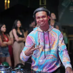 Rocking a tie-dye hoodie and sharing good vibes. This is me posing for a quick photo while keeping the party going.