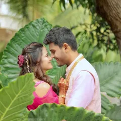An intimate couple portrait, framed by large leaves, creating a natural and private feel for this romantic shot.