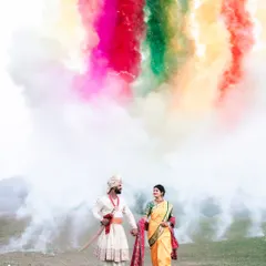 A moment of pure magic for this beautiful Marathi couple. We used vibrant color smoke to create a stunning, ethereal backdrop against the natural landscape, making for an unforgettable pre-wedding portrait.