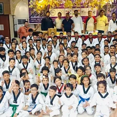 The entire academy gathered for a photo after a Belt Promotion Test. Seeing students advance through the Taekwondo belt system, from white to black, is a reward in itself.