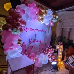 A different view of the butterfly theme decor, showing the soft lighting and how the metallic balloons catch the light beautifully.