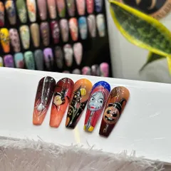 Getting into the spooky spirit with this full set of Halloween-themed nail art. Inspired by "The Nightmare Before Christmas," this collection includes hand-painted characters, pumpkins, spiderwebs, and haunted houses.