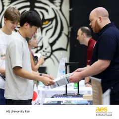 A student from our diverse international community receives information from a university representative. We provide high school application support for universities in any country, catering to our global student body.