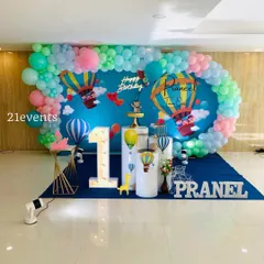 A wide shot of a hot air balloon setup, showing the full balloon garland that wraps around the backdrop.