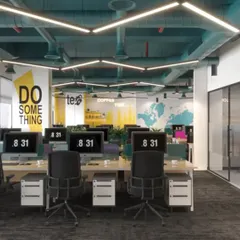 The vibrant, open-plan workspace for EAII Advisors in New Delhi. This design concept focuses on employee well-being and collaboration, with exposed ceilings for an industrial feel, custom hexagonal lighting, and brand colors integrated into the decor.