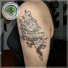 A Bhutanese dragon tattoo on the upper arm. This is a less common style of dragon, and we enjoyed creating this unique linework and stippling piece for the client.