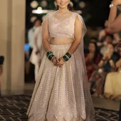 A full view of this bride's sangeet look. The light pink lehenga is paired with a soft glam makeup look, perfect for an evening of celebration.