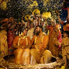 A grand celebration as family and friends shower the couple with flower petals during their Haldi. This shot captures the scale and joy of the event.