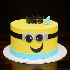 A fun Minion cake for a fourth birthday celebration. I used mostly buttercream to get those crisp, clean edges, with just a few fondant details for the eyes and smile. It's a cheerful and instantly recognizable design.