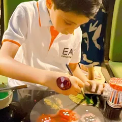 A young guest carefully painting his masterpiece at a birthday party. I provide all the necessary art supplies and guidance for a fun, hands-on experience.
