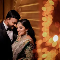 A quiet moment for the couple amidst the grand reception. We love using creative lighting like this beautiful bokeh effect to create romantic, artistic portraits that feel both intimate and grand.